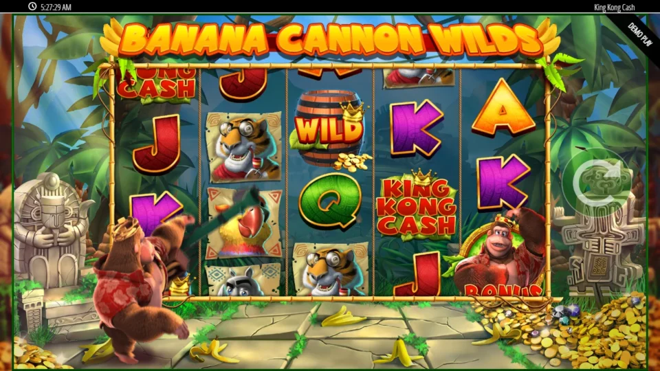King Kong Cash: Banana Cannon Wilds banner as Kong fires at the reels, a Wild barrel already standing on reel 3